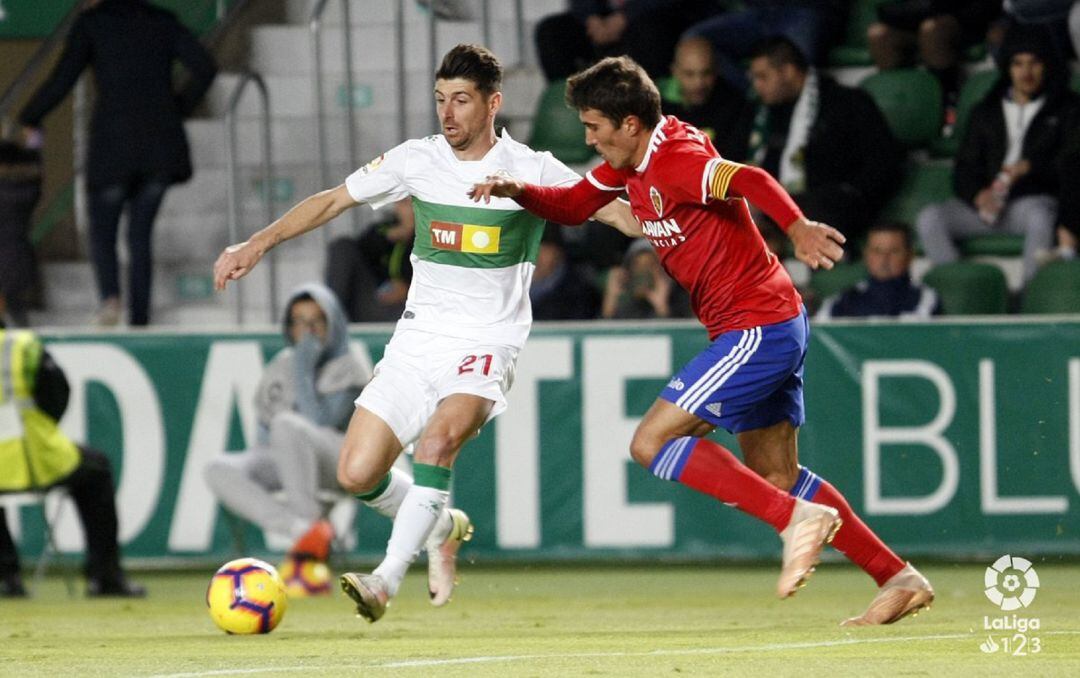 Javi Flores controla el balón ante Zapater, el capitán del Zaragoza