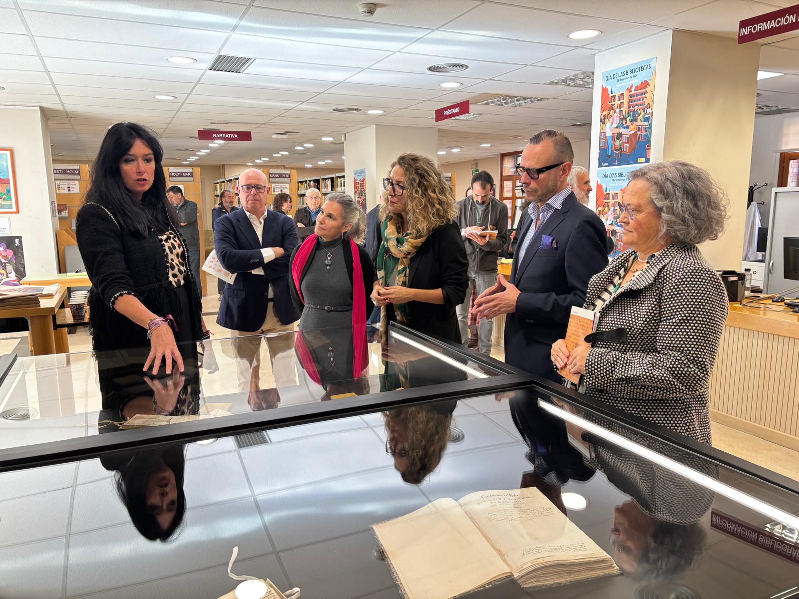 Un momento de la visita a la exposición de libros de la Biblioteca Pública de Huesca