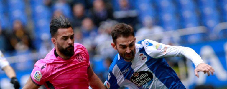  El delantero del Deportivo Adrián López (d), pelea un balón con el delantero del Levante Ivi, durante el partido correspondiente a la vigésima primera jornada de LaLiga Santander en el estadio de Riazor. 