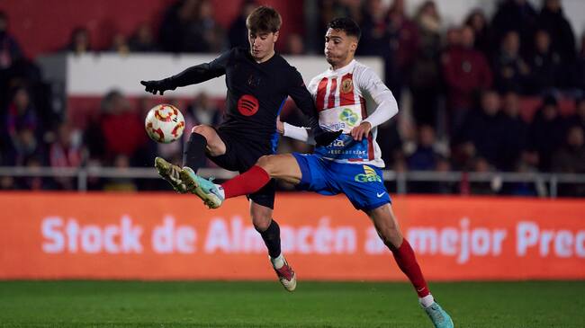 BARBASTRO, SPAIN - JANUARY 04: Pablo Torre of FC Barcelona competes for the ball with Israel Garcia of UD Barbastro during the Copa del Rey Round of 32 match between FC Barcelona and UD Barbastro at Campo Municipal de Deportes on January 04, 2025 in Barbastro, Spain. (Photo by Pedro Salado/Getty Images)
