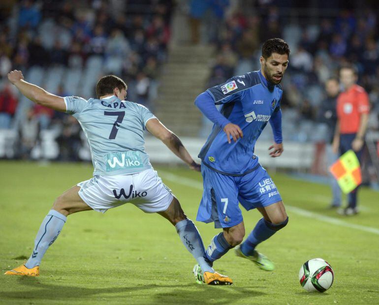 GRA322. GETAFE, 05/12/2014.- El centrocampista del Getafe, Ángel Lafita (c), se lleva el balón ante el jugador del Eibar, Ander Capa (c), durante el encuentro correspondiente a la ida de los dieciseisavos de final de la Copa del Rey, que disputan esta noche en el Coliseum Alfonso Pérez de la localidad madrileña. EFE / Luca Piergiovanni.