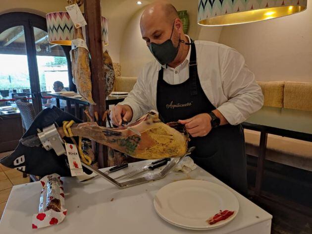 Alejandro Vega, cortando a cuchillo una paletilla ibérica de Beher