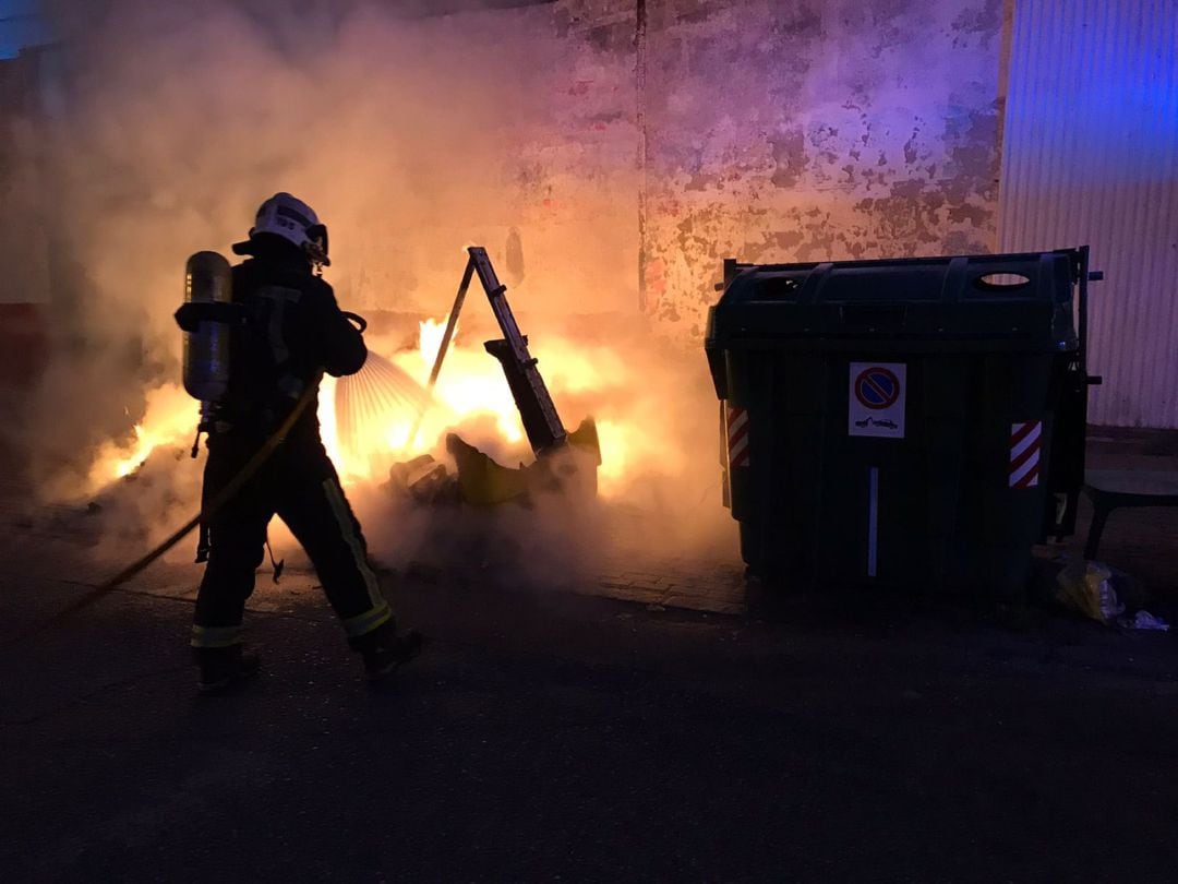 Bomberos de Córdoba sofocando un incendio en un contenedor. Foto de archivo