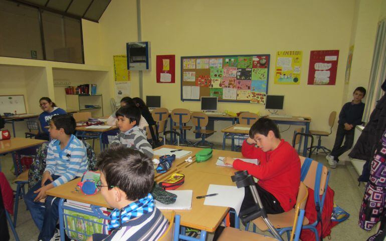 Niños dando clases en un colegio.