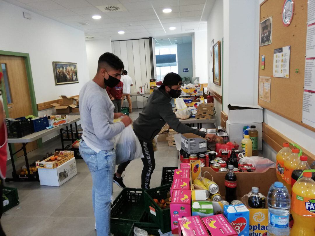 Jóvenes colaboran en el reparto de comida