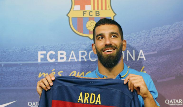 GRA070. BARCELONA, 10/07/2015.- El centrocampista turco Arda Turan, posa con su camiseta durante la rueda de prensa en la que ha sido presentado como nuevo jugador del Barcelona para las próximas cinco temporadas. EFE/Alejandro García