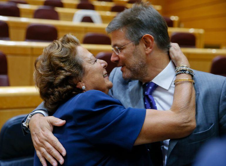 GRA271. MADRID, 01/09/2015.- El ministro de Justicia, Rafael Catalá (d), saluda a Rita Barberá (i) durante el pleno, en el que la exalcaldesa de Valencia ha tomado posesión de su cargo como nueva senadora, hoy en el Senado. EFE/Juanjo Martin
