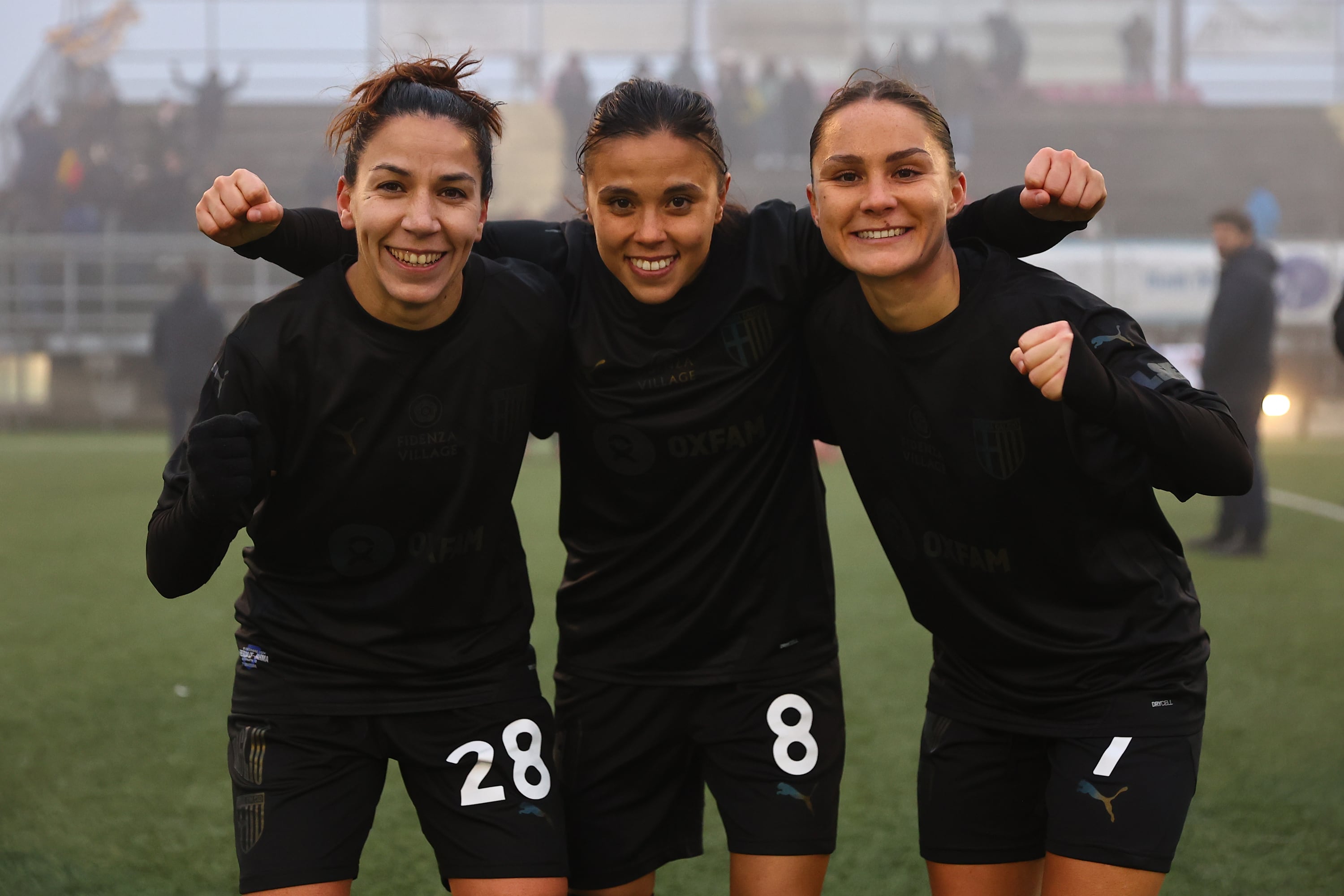 BRESCIA, ITALY - DECEMBER 15: (L-R) Zhanna Ferrario of Parma Calcio 1913, Giada Pondini of Parma Calcio 1913 and Iris Madeleine Rabot of Parma Calcio 1913 celebrate victory after the Serie B Women match between Brescia and Parma Calcio on December 15, 2024 in Brescia, Italy. (Photo by Luca Amedeo Bizzarri - Parma Calcio 1913/Parma Calcio 1913 via Getty Images)