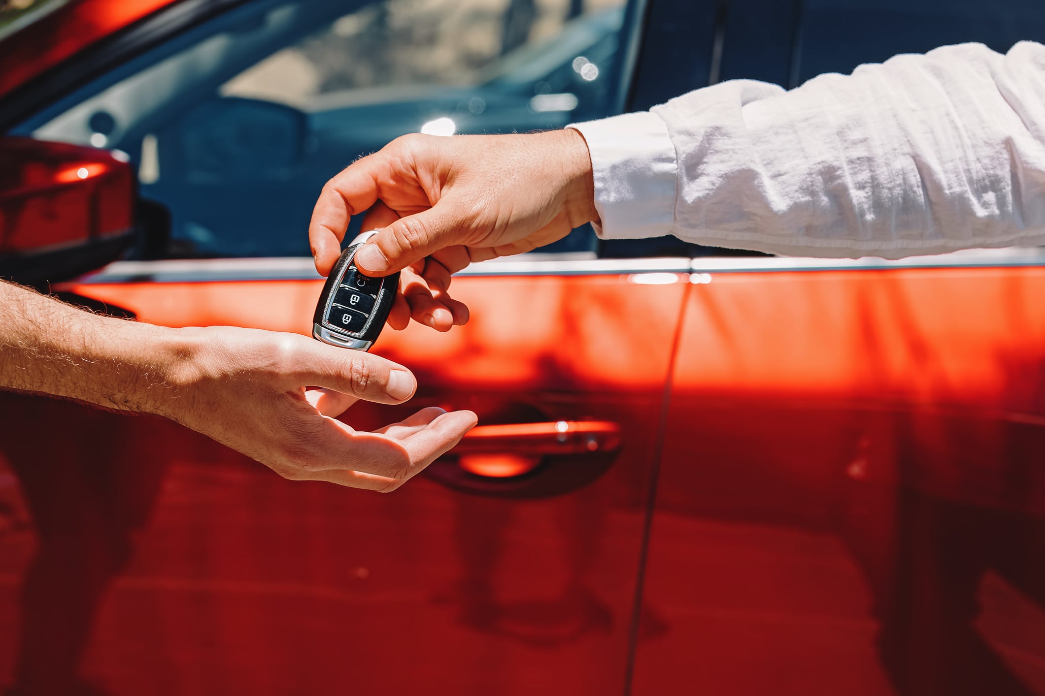 Un empleado entrega las llaves del coche a su cliente.