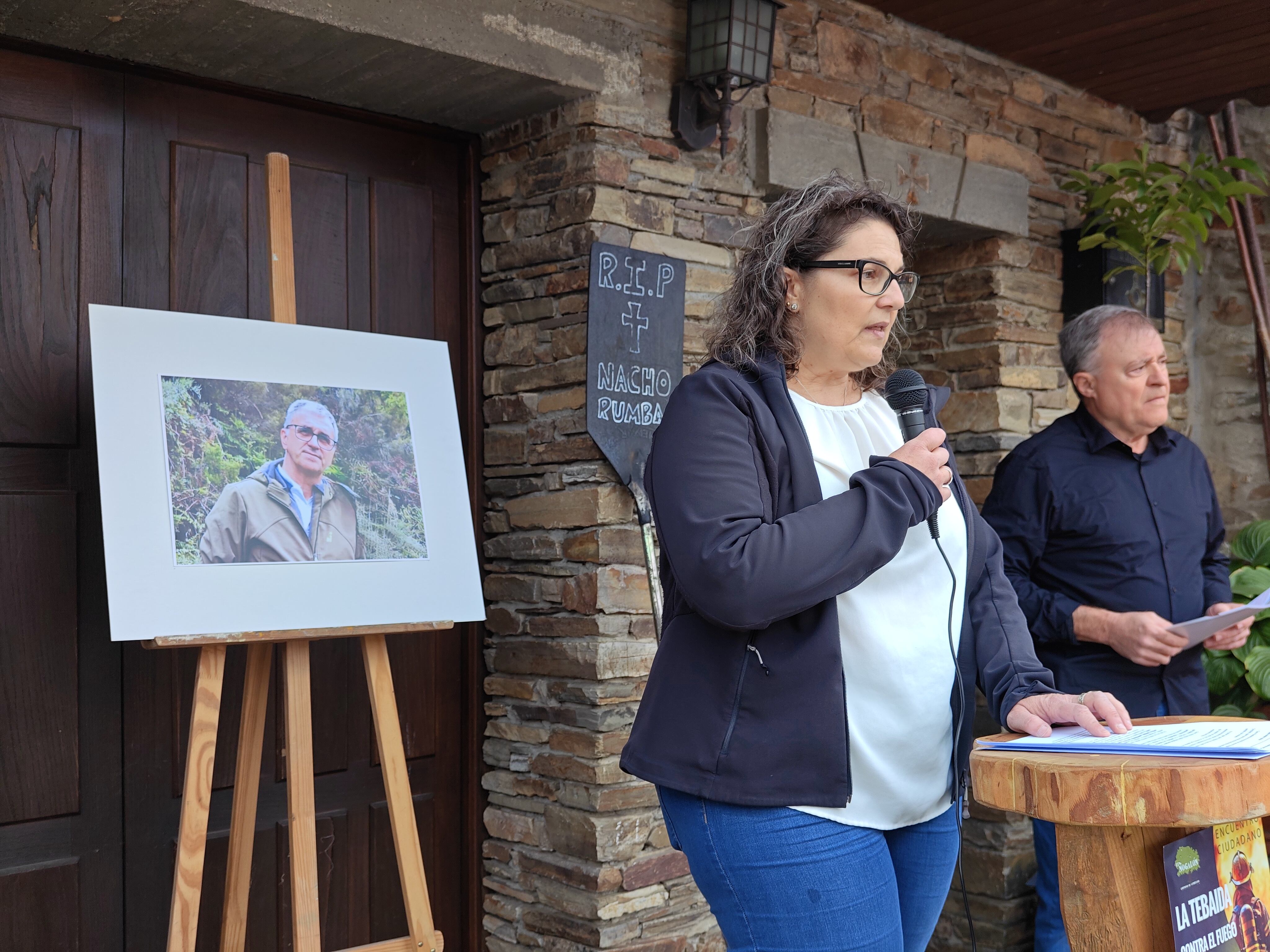 Intervención de la Asociación el Nogalón con la foto y el batefuegos de Nacho al fondo