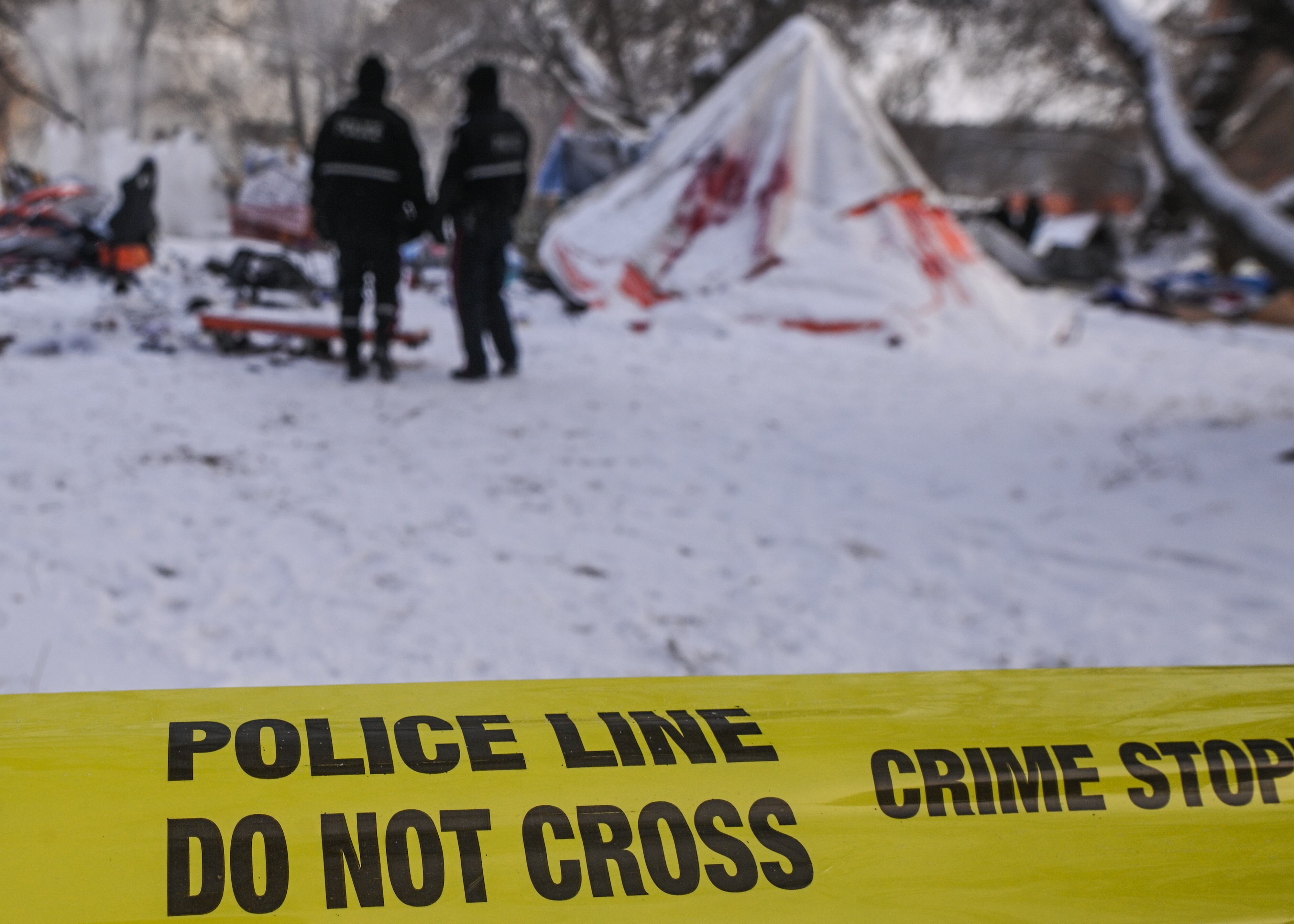 Police tape secures the area as city crews remove the last of eight high-risk homeless encampments near 95th Street and 101A Avenue in downtown Edmonton.