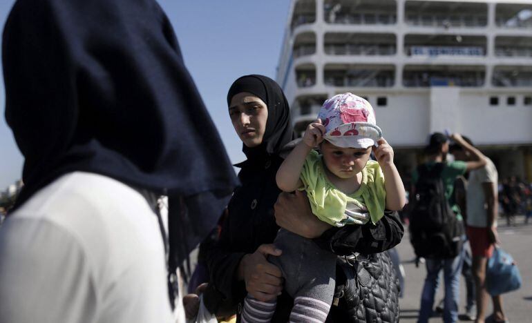 Varios refugiados sirios desembarcan del buque &quot;Eleftheros Venizelos&quot; en el puerto del Pireo, cerca de Atenas