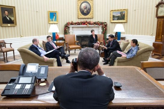 President Barack Obama talks on the phone during National Security Council (NSC) call time in the Oval Office, Dec. 16, 2014. (Official White House Photo by Pete Souza)