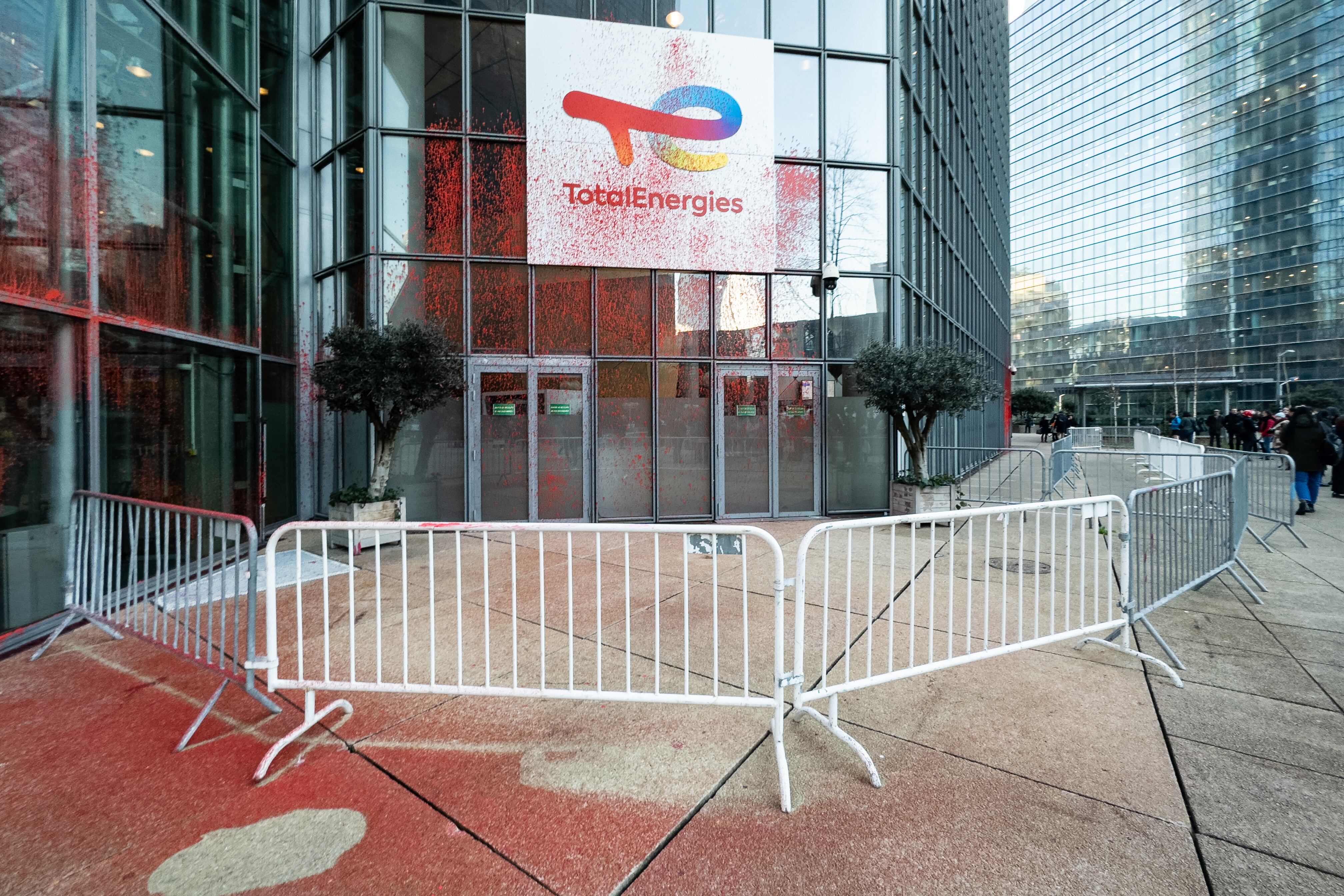 Environmental activists from the Alternatiba citizen movement covered the headquarters of the TotalEnergies group in the La Defense district of Paris with red and black paint on 8 February 2023. They denounced the group&#039;s ecological footprint the day after it published record profits. (Photo by Samuel Boivin/NurPhoto via Getty Images)