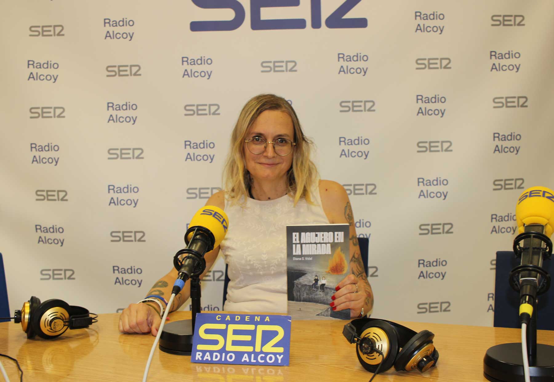 Diana Cortés, amb un exemplar del llibre que acabar de publicar, en l&#039;estudi central de Radio Alcoy