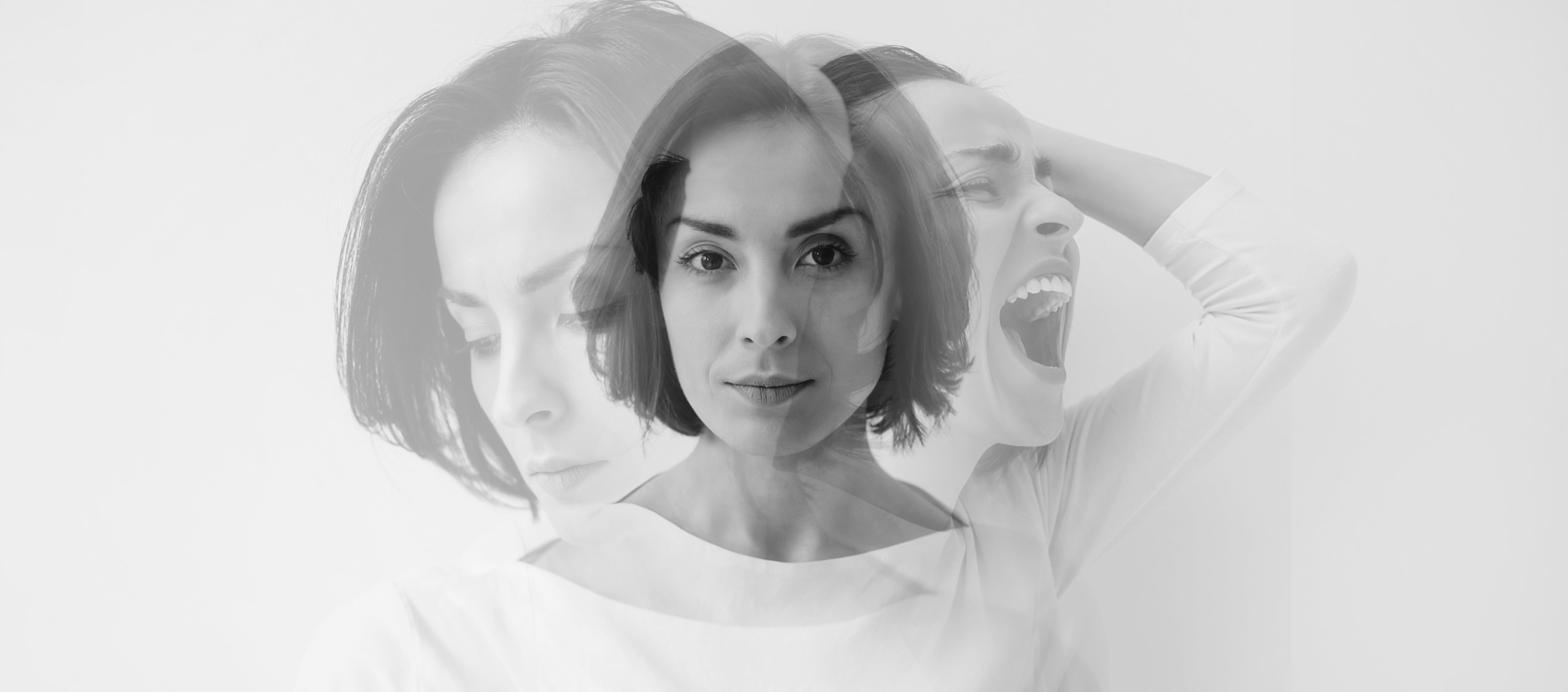 Young pretty brunette girl who is looking in the camera while internally suffering from a dissociative identity disorder. Double exposure.