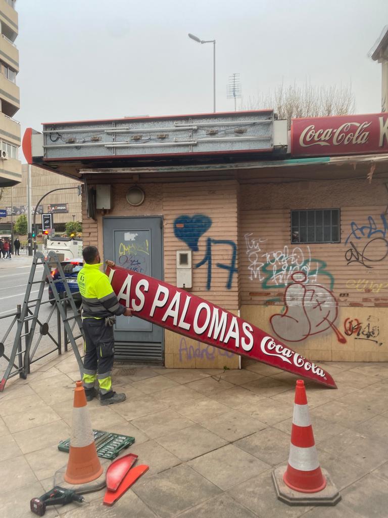 Un operario retira el letrero del kiosko &#039;Las Palomas&#039;.