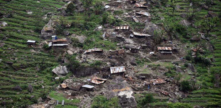 TOPSHOTS Damaged houses are seen from an Indian Army helicopter following an earthquake in the Nepalese area of Gorkha on April 28, 2015. Hungry and desperate Nepalese villagers rushed towards a relief helicopter begging to be airlifted to safety April 2