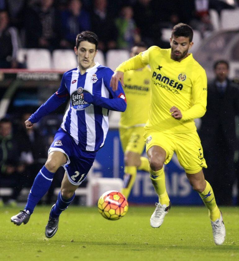 El centrocampista del Deportivo Luis Alberto Romero (i) pelea un balón con el defensa del Villarreal Mateo Musacchio (d) durante el encuentro de la decimoctava jornada de Liga, disputado entre ambos equipos en el estadio de Riazor