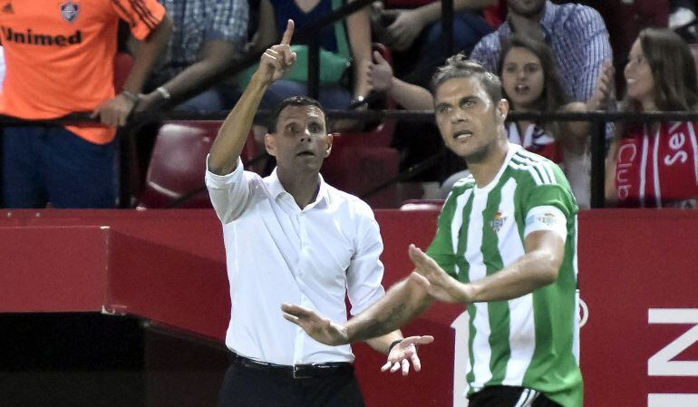 GRA638. SEVILLA.- El entrenador del Real Betis Gustavo Poyet (i) y el centrocampista Joaquín Sánchez (d), durante el partido de la quinta jornada de Liga en Primera División que Sevilla y Betis disputan esta noche en el estadio Sánchez Pizjuán, en Sevilla