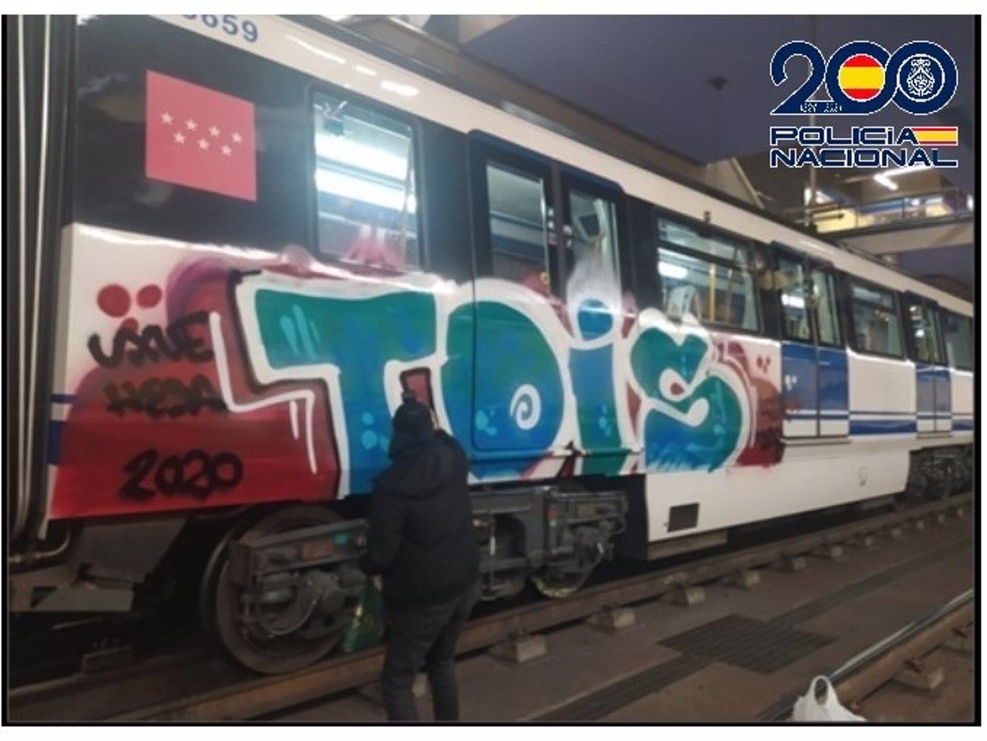 Grafitero pintando tren de RENFE