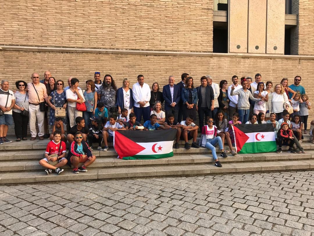 Niños y niñas saharauis, familias de acogida y representantes de grupos parlamentarios de las Cortes de Aragón. 