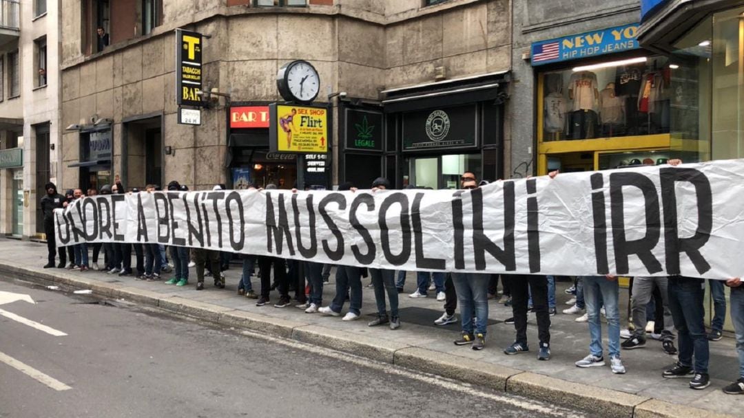 Ultras de la Lazio sostienen pancartas en apoyo a Benito Mussolini.