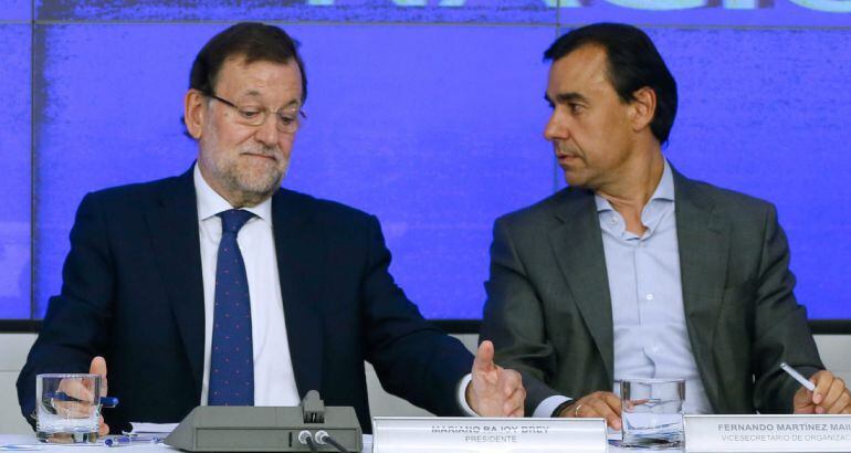 El presidente del Gobierno y del Partido Popular, Mariano Rajoy, junto al vicesecretario de Organización del PP, Fernando Martínez Maillo (d)