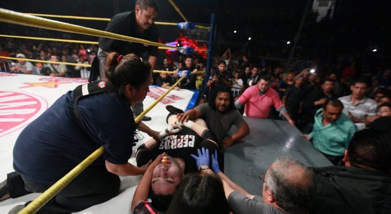 El luchador mexicano Pedro "Perro" Aguayo Jr. recibe atención en la noche del viernes 20 de marzo de 2015 tras recibir una patada voladora de su rival, Rey Misterio.