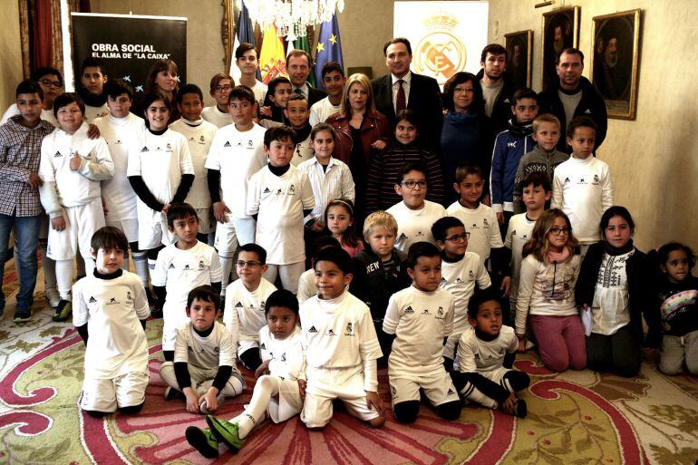 Emilio Butragueño, acompañado de la alcaldesa, Manuel Caro (Caixabank) y los alumnos de la Escuela de la Fundación del Real Madrid.