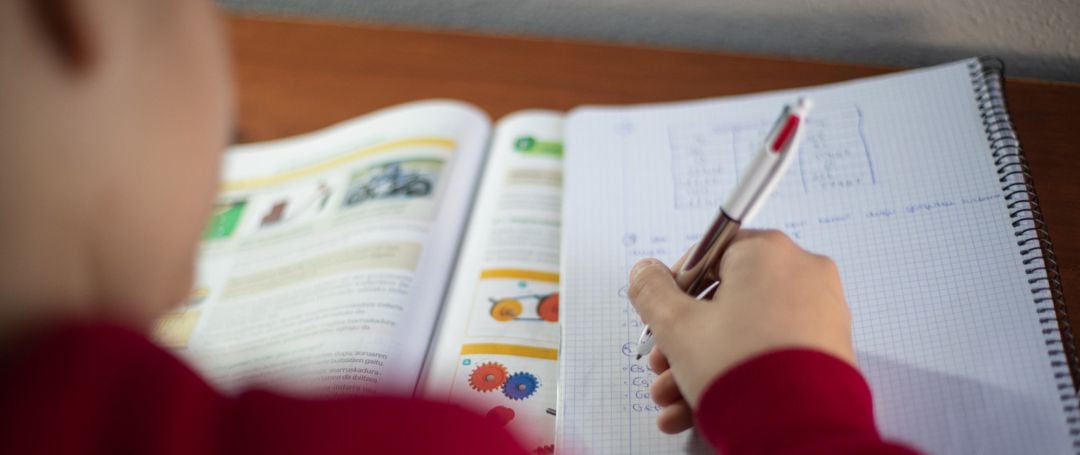 Un niño realiza sus deberes en su habitación durante el confinamiento por el estado de alarma