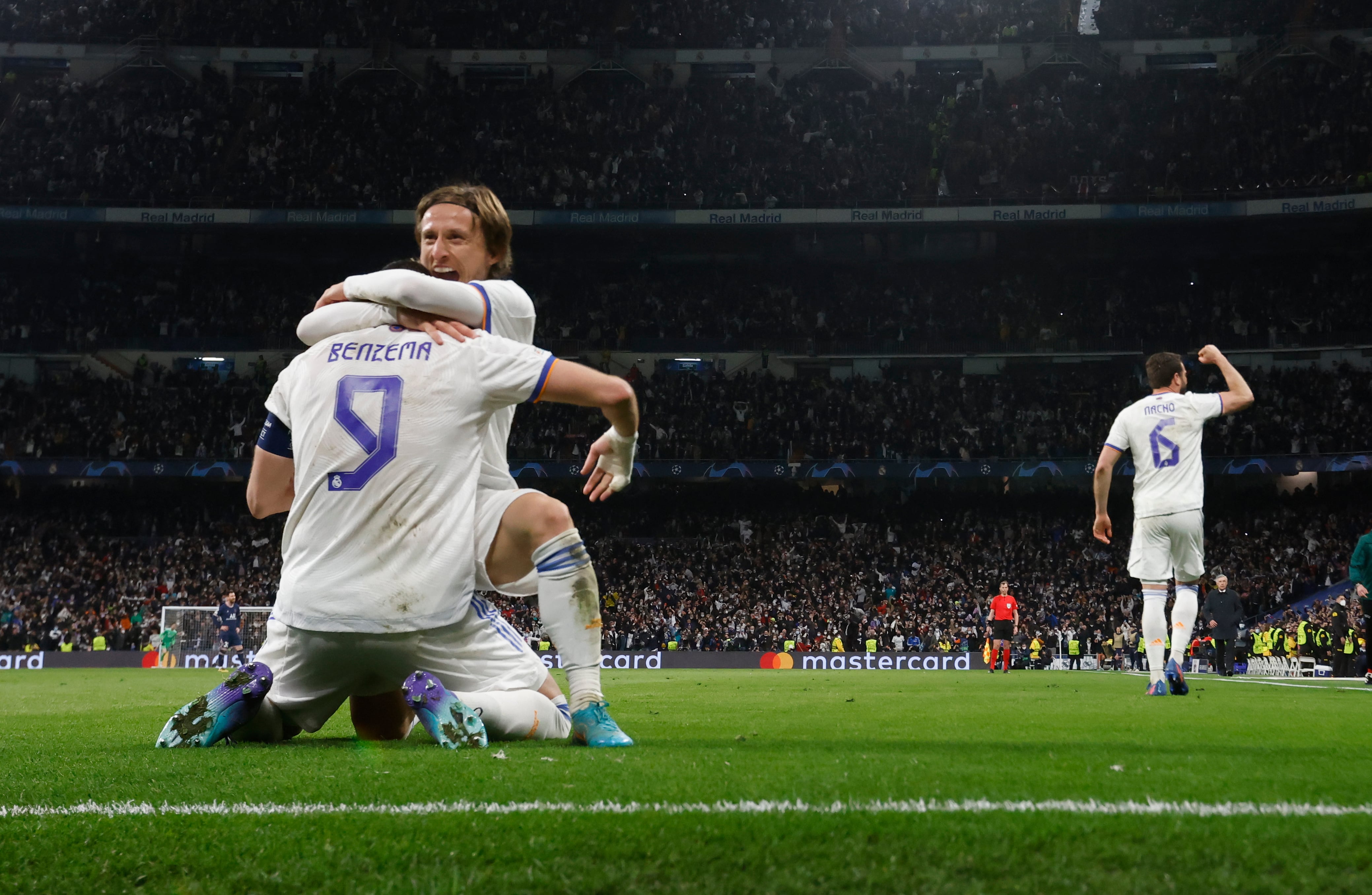 El delantero francés del Real Madrid Karim Benzema (de espaldas) celebra con Luka Modric el pase del equipo blanco a los cuartos de final de la Liga de Campeones.