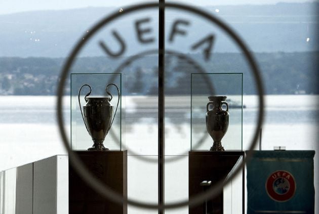 Nyon (Switzerland Schweiz Suisse).- (FILE) - The UEFA Champions League trophy (L) and the Henri Delaunay trophy (R) of the UEFA EURO soccer championship on display at the UEFA headquarters in Nyon, Switzerland, 18 September 2014