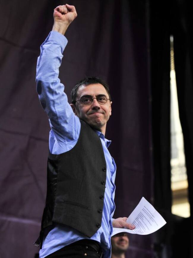 Podemos member Juan Carlo Monedero holds up his fist on stage at Puerta del Sol during the "March for Change" planned by left-wing party Podemos that emerged out of the "Indignants" movement, in Madrid on January 31, 2015. Tens of thousands of people took