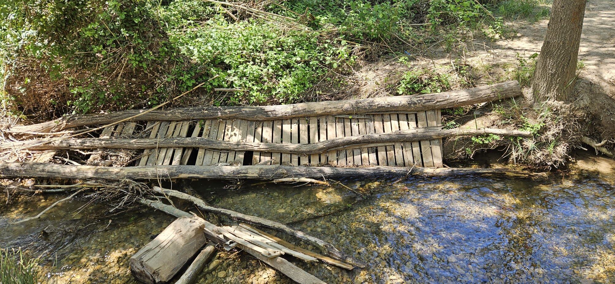 Una de las pasarelas, tirada sobre el cauce del río