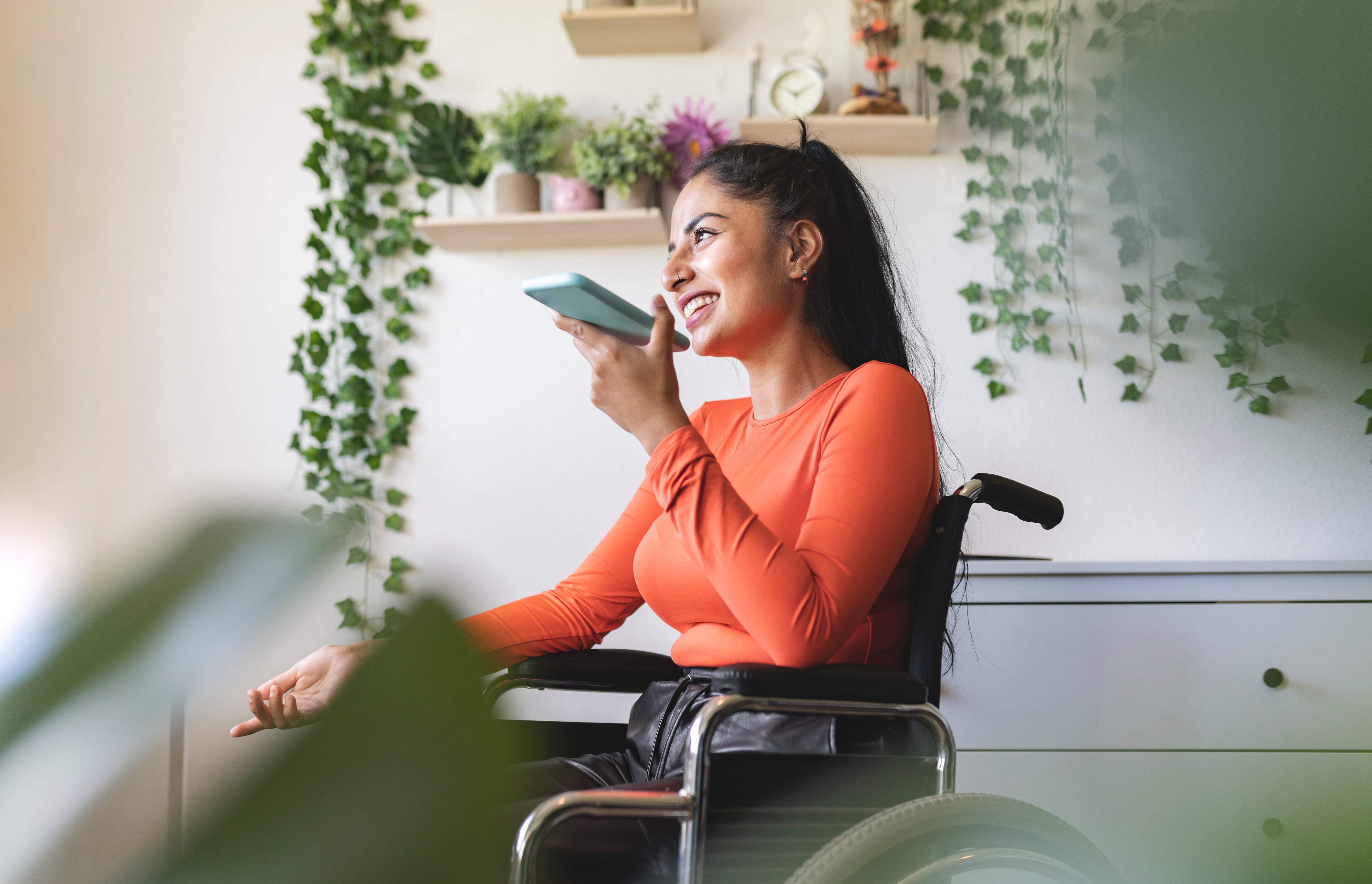 Smiling disabled woman talking on mobile phone at home