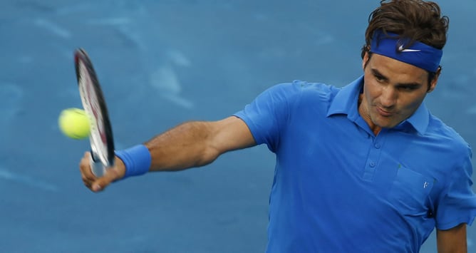 El tenista suizo Roger Federer golpea la bola en su partido ante el francés Richard Gasquet correspondiente a los octavos de final del Masters 1.000 de Madrid, que se disputa el 10 de mayo de 2012, en las instalaciones de la Caja Mágica