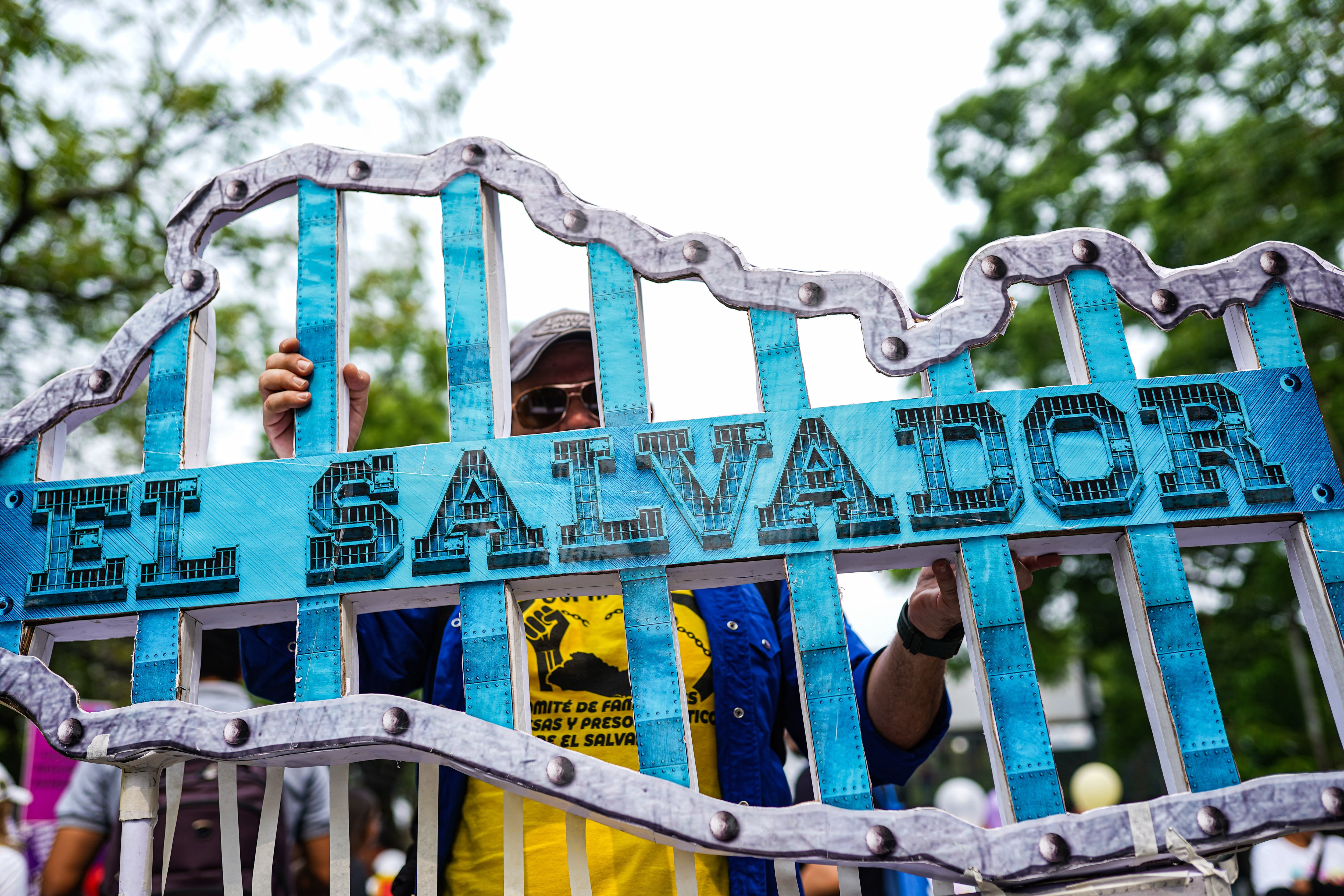 SAN SALVADOR, EL SALVADOR - 2023/05/01: A demonstrator holds a sign depicting the Salvadoran map behind bars during a protest on International Workers&#039; Day. In commemoration of International Workers&#039; Day, protesters demonstrated against the Salvadoran government as President of El Salvador Nayib Bukele pushes for re-election which is deemed unconstitutional by the opposition. Also, protesters demonstrated against the high cost of living and human rights abuses. (Photo by Camilo Freedman/SOPA Images/LightRocket via Getty Images)