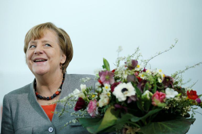 Chancellor Angela Merkel receives Valentine&#039;s Day flowers from the Central Gardening Association at the Chancellery in Berlin, Germany