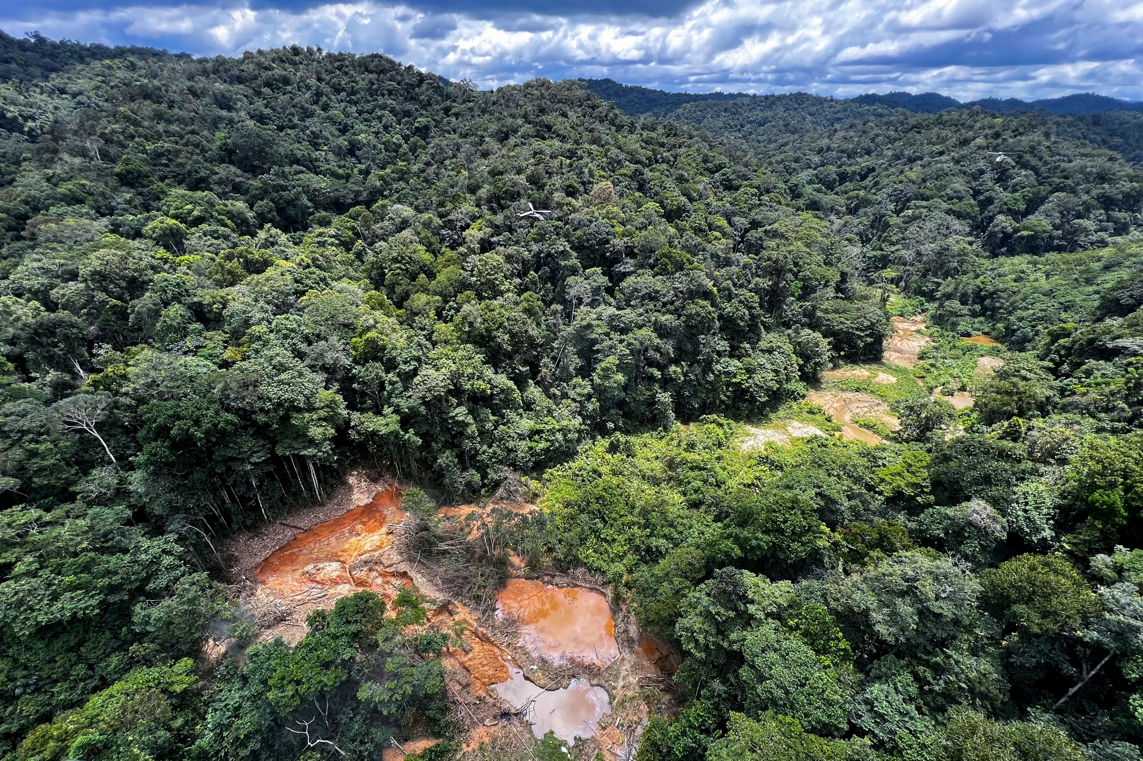 Aerial picture showing an illegal mining camp, known as garimpo, during an operation by the Brazilian Institute of Environment and Renewable Natural Resources (IBAMA) against Amazon deforestation at the Yanomami territory in Roraima State, Brazil, on February 24, 2023. - In early February Brazil deployed hundreds of police and soldiers to evict gold miners accused of causing a humanitarian crisis on the Yanomami Indigenous reservation, as thousands of the illegal miners fled. Justice Minister Flavio Dino said authorities estimate at least 15,000 people have illegally invaded the protected Amazon rainforest reservation, where Indigenous leaders accuse gold miners of raping and killing inhabitants, poisoning their water with mercury and triggering a food crisis by destroying the forest. (Photo by ALAN CHAVES / AFP) (Photo by ALAN CHAVES/AFP via Getty Images)