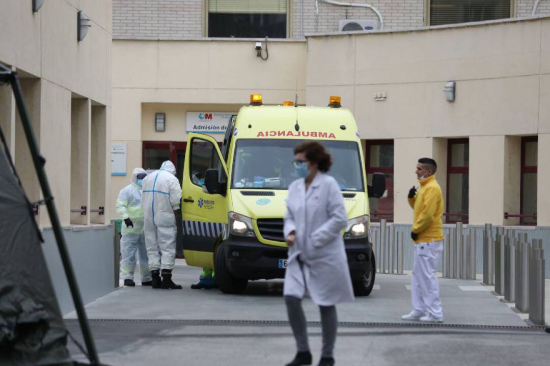 Personal sanitario pasa junto al área donde militares del Mando de Ingenieros de Salamanca del Ejército de Tierra, una unidad de 34 militares, instalan un hospital provisional de entre 60 y 70 camas en las inmediaciones del Hospital Gregorio Marañón, en Madrid. 