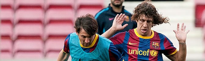 Puyol, junto a Messi, durante un entrenamiento