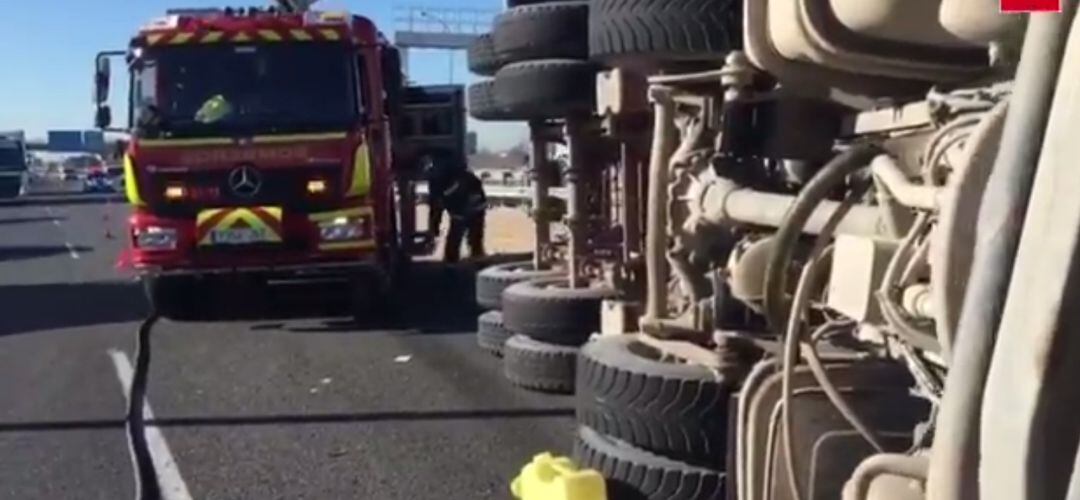 El vuelco del camión dejó atrapado en la cabina al conductor que ha sufrido heridas leves. 