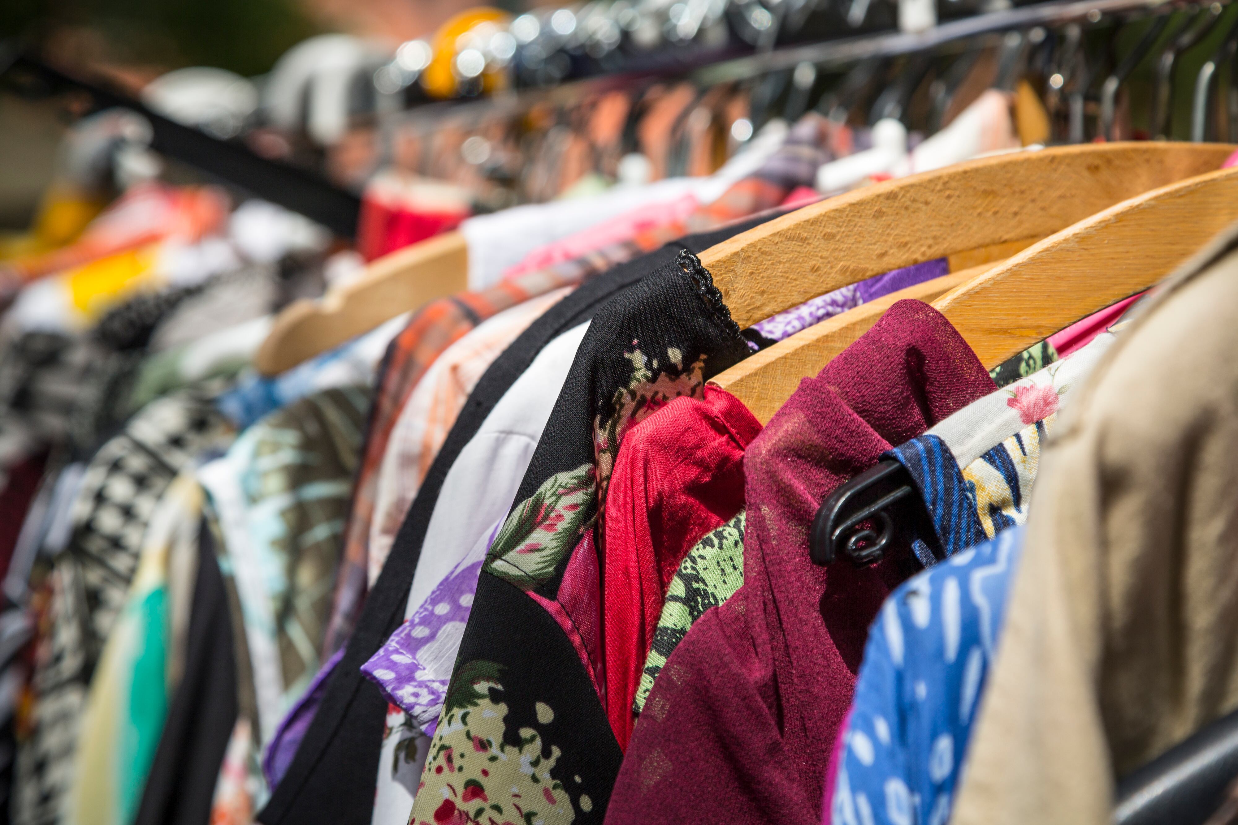 clothes on a rack on a flea market.