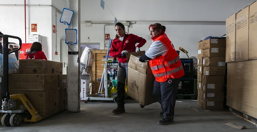 Personal de Cruz Roja Española prepara material para repartir a los afectados por la DANA en el almacén de la organización en Pinedo.