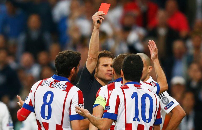 MADRID, SPAIN - APRIL 22: Arda Turan of Atletico Madrid (10) is sent off by referee Felix Brych during the UEFA Champions League quarter-final second leg match between Real Madrid CF and Club Atletico de Madrid at Bernabeu on April 22, 2015 in Madrid, Sp