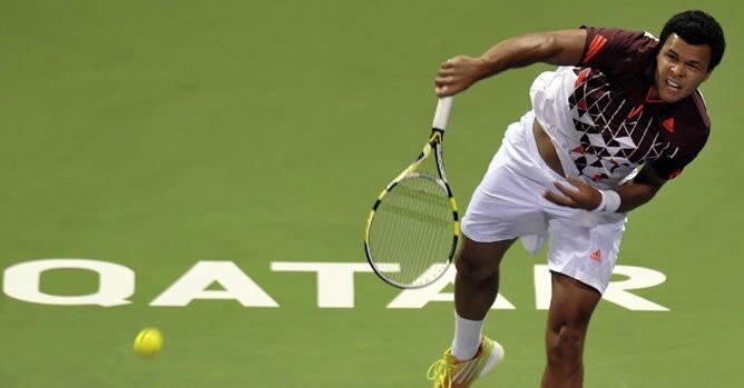 El tenista francés Jo-Wilfried Tsonga sirve ante su rival, el también francés Gael Monfils, durante la final del torneo abierto de tenis de Doha