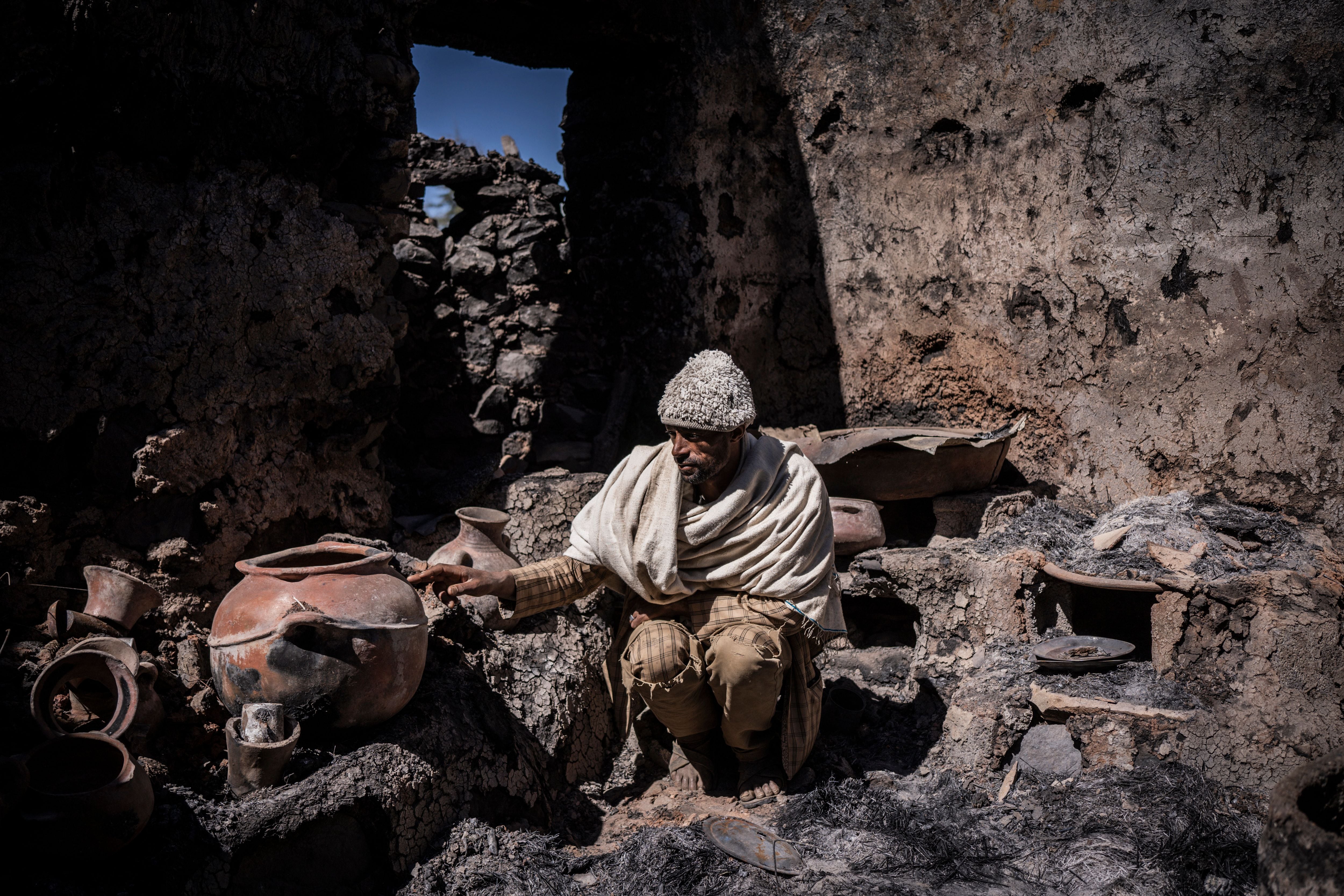 Fekede Amare, 41, shows his burned down house, allegedly attacked by Tigray forces in Mesobit, Ethiopia, on December 06, 2021. (Photo by Amanuel Sileshi / AFP) (Photo by AMANUEL SILESHI/AFP via Getty Images)