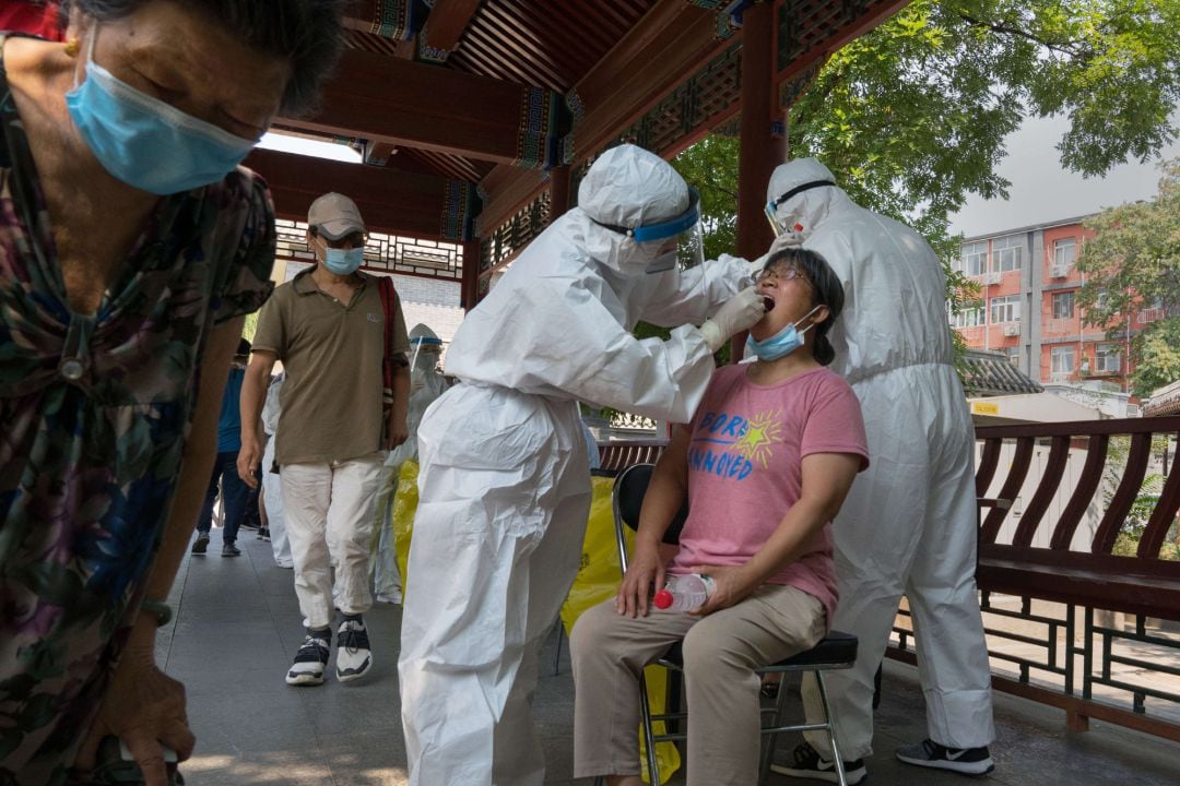 Una mujer se realiza la prueba de la COVID-19 en Pekín