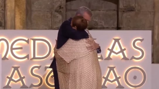 Alfonso Rueda abraza a Maite Isla tras imponerle la Medalla Castelao